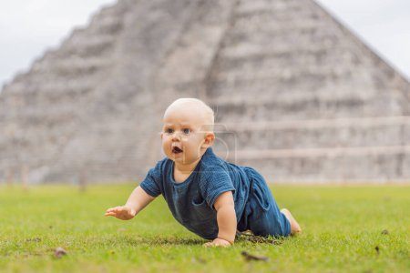 Photo for Baby traveler, tourists observing the old pyramid and temple of the castle of the Mayan architecture known as Chichen Itza. These are the ruins of this ancient pre-columbian civilization and part of - Royalty Free Image