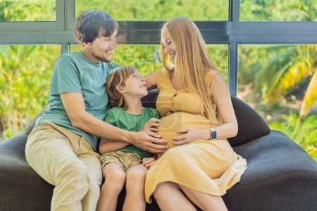 Cozy family time at home as pregnant mom, dad, and son enjoy shared moments on the sofa, creating heartwarming memories and cherishing their time together.