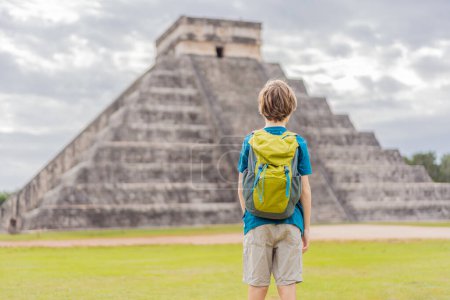 Boy traveler, tourists observing the old pyramid and temple of the castle of the Mayan architecture known as Chichen Itza. These are the ruins of this ancient pre-columbian civilization and part of