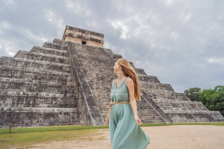 Beautiful tourist woman observing the old pyramid and temple of the castle of the Mayan architecture known as Chichen Itza. These are the ruins of this ancient pre-columbian civilization and part of