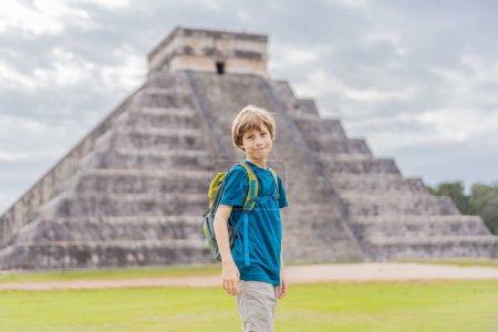 Boy traveler, tourists observing the old pyramid and temple of the castle of the Mayan architecture known as Chichen Itza. These are the ruins of this ancient pre-columbian civilization and part of