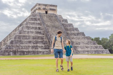 Father and son tourists observing the old pyramid and temple of the castle of the Mayan architecture known as Chichen Itza. These are the ruins of this ancient pre-columbian civilization and part of