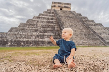 Baby traveler, tourists observing the old pyramid and temple of the castle of the Mayan architecture known as Chichen Itza. These are the ruins of this ancient pre-columbian civilization and part of