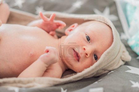 Photo for Baby after shower wrapped in a towel. This adorable moment captures the freshness and comfort of a clean baby, highlighting the tender care and love in the daily routine. - Royalty Free Image