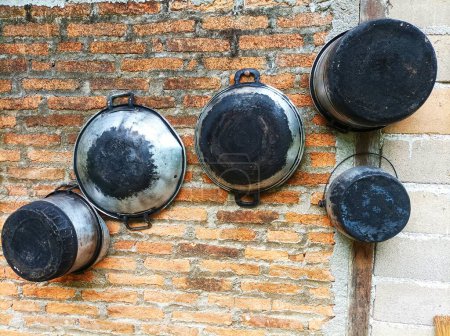 Photo for Pots, steamers, and cauldrons hanging on the walls - Royalty Free Image