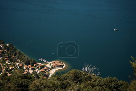             the view of the city and the sandy peninsula on the shores of Lake Como from above                   