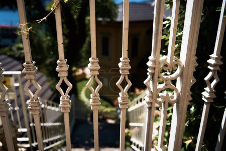          white wrought iron fence in an Italian town, details, background                      