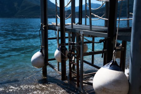          the   white round buoys on the pier near Lake Como                    