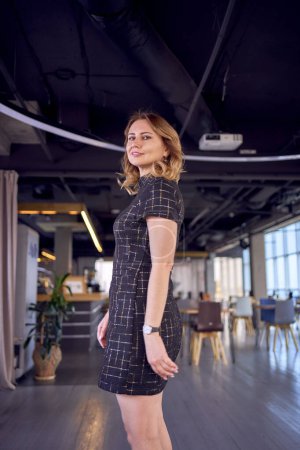 a stunning model in business mini dress catwalk in modern office space                              