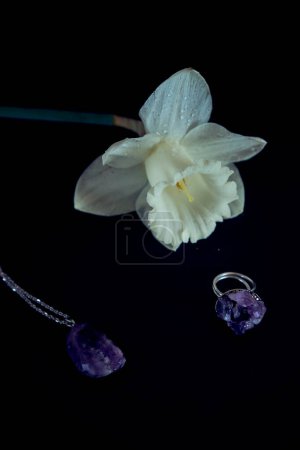    an amethyst ring and pendant necklace with delicate narcissus petals                           