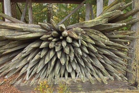 Pile of old wood hay stakes in shelter.