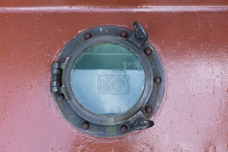 Round porthole window on old ship.