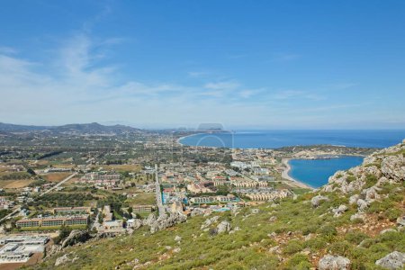 View of town of Kolymbia and sandy beach in sunny spring weather, Rhodes, Greece.