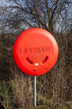 Life saving equipment buoy on a grey post in the park near the Boyne River in Ireland
