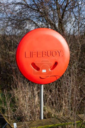 Life saving equipment buoy on a grey post in the park near the Boyne River in Ireland