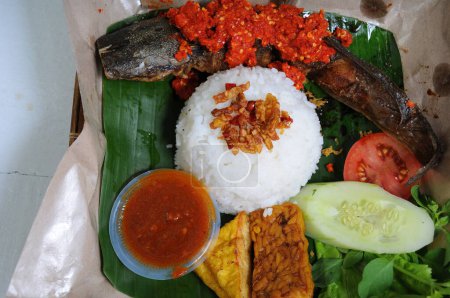Photo for Fried Catfish Balado Sauce Served Fried tempeh tofu and vegetables as well as special spicy chili sauce - Royalty Free Image