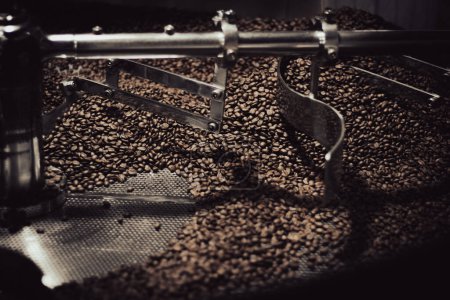 Photo for Close up of beans in a stainless steel industrial coffee roaster for an artisan coffee maker. - Royalty Free Image