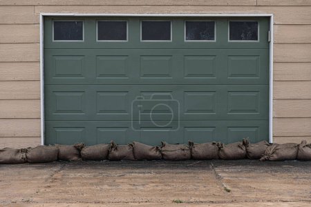 After the storm - sandbags against the door to keep the garage dry from the natural disaster weather bomb that was Cyclone Gabrielle in 2023.