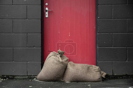 After the storm - sandbags against the door to keep shops dry from the natural disaster weather bomb that was Cyclone Gabrielle in 2023.