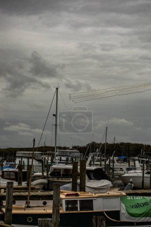 Photo for Thames, New Zealand, 27 January 2024: Wings and Wheels event. View from the Thames Wharf of the aerial acrobatics of some of the WW2 fighter planes - Royalty Free Image