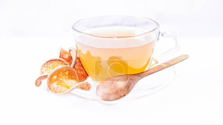 Herbal drink, Bael fruit juice, dried in a clear glass cup. healthy on white background isolate