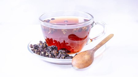 Herbal drink, black goji berry, dried in a clear glass cup. healthy on white background isolated