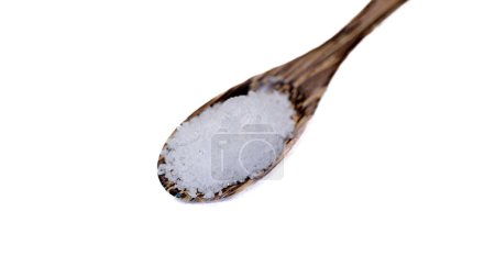 Close-up shot of table salt mixed with white iodine in a wooden spoon. It's for seasoning food. White background. Isolated