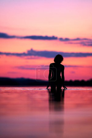 Photo for Women silhouette sunset on the lake. High quality photo - Royalty Free Image