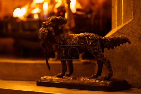 Photo for Hunter dog statue beside fireplace. High quality photo - Royalty Free Image