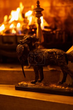 Photo for Hunter dog statue beside fireplace. High quality photo - Royalty Free Image