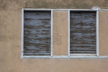 Photo for Old roller shutters lowered in a window - Royalty Free Image