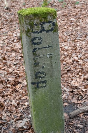 mossy boundary stone in the forest with the inscription Bottrop Oberhausen