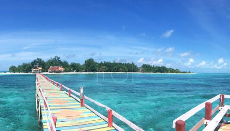 This colorful wooden pier will take you to Tinabo Island which has the charm of white sandy beaches, clear turquoise sea with the beauty of life in the sea, decorated with blue skies, in Taka Bonerate, South Sulawesi, Indonesia.