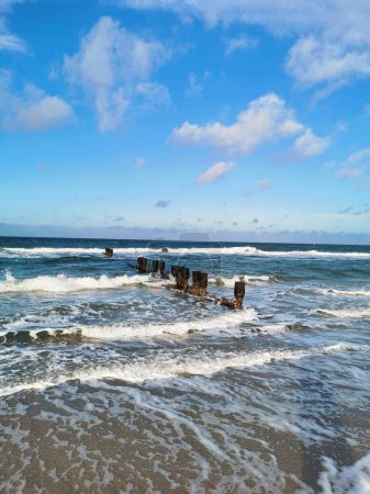Waves and groynes at the shore of the Baltic Sea near to the city of Rostock (Germany)