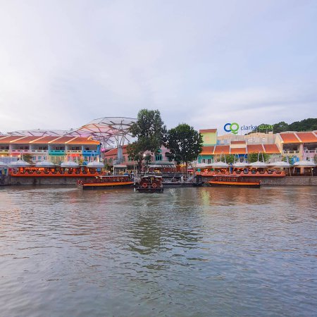 Photo for Singapore - January 01 2023: Clarke Quay at Sunset, view of Cruise Riverboats berthed and passing along the Singapore River with colorful traditional Chinese Peranakan shophouses at the background - Royalty Free Image