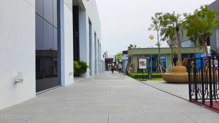 Photo for Jakarta Nov 01 2023: wide pedestrian walkway at Indonesia Design District PIK2 Outdoor Strip Mall. with several shops buildings and landscaping. - Royalty Free Image