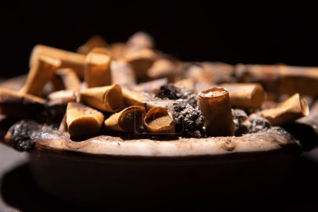 Photo for Close up of pile cigarette butts in the ashtray - Royalty Free Image