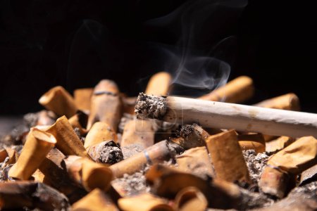 Photo for Smoldering cigarette and smoky on the ashtray - Royalty Free Image
