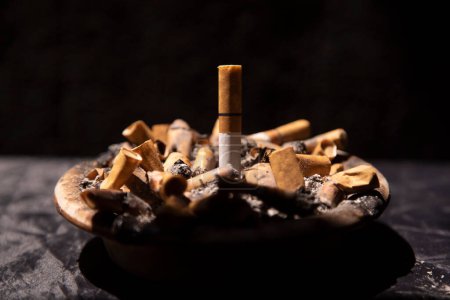 Photo for Turning off cigarettes in the ashtrays full of butts - Royalty Free Image