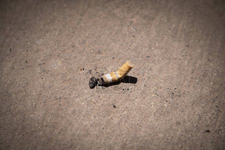 Photo for Top view of cigarette butts isolated in the floor - Royalty Free Image