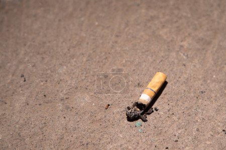 Photo for A cigarette butts in the brown floor - Royalty Free Image