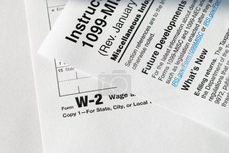 Photo for 1099 Misc. and W2 Internal Revenue Service tax forms.Tax time in the USA - Royalty Free Image