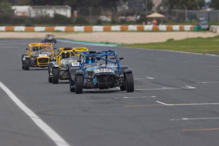 Photo for 11-20-2022 PORTUGAL, LISBON: Caterham festival - racing karts driving in a row on the track. Mid shot - Royalty Free Image