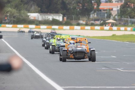 Photo for 11-20-2022 PORTUGAL, LISBON: Caterham festival - racing karts driving on the track in a row. Mid shot - Royalty Free Image