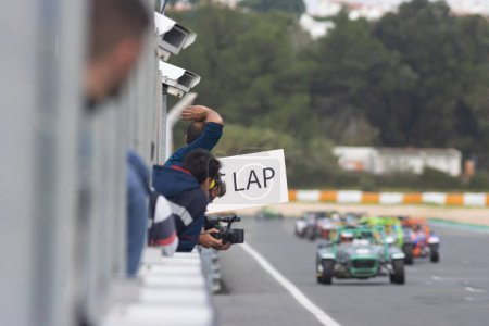 Photo for Kart racing - a man holding a placard with lap counting. Mid shot - Royalty Free Image