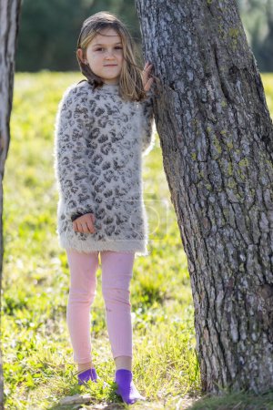 Photo for Cute little girl 7 years old in the summer park - portrait near tree - Royalty Free Image