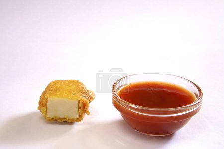 Photo for Indian cuisine , fast food starters Cheese Pakode puffs served with tomato ketchup in dish on white background - Royalty Free Image