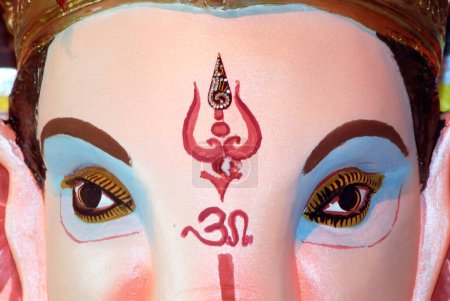 Close up of lord ganesh elephant headed god om and trishul painted on forehead for Ganpati festival year 2008 at Borivali , Bombay Mumbai , Maharashtra , India