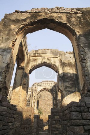 Golconda fort built by Mohammed Quli Qutb Shah 16th century view of ruined walls multiple arches , Hyderabad , Andhra Pradesh , India