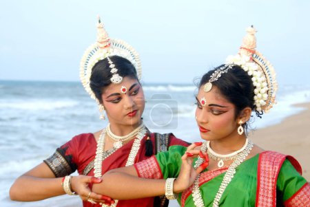 Photo for Dancers performing classical traditional odissi dance in front of bay of Bengal sea, Konarak, Orissa, India - Royalty Free Image